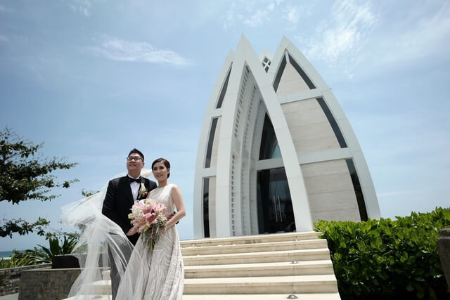 Bride and Groom standing on steps on Majestic chapel