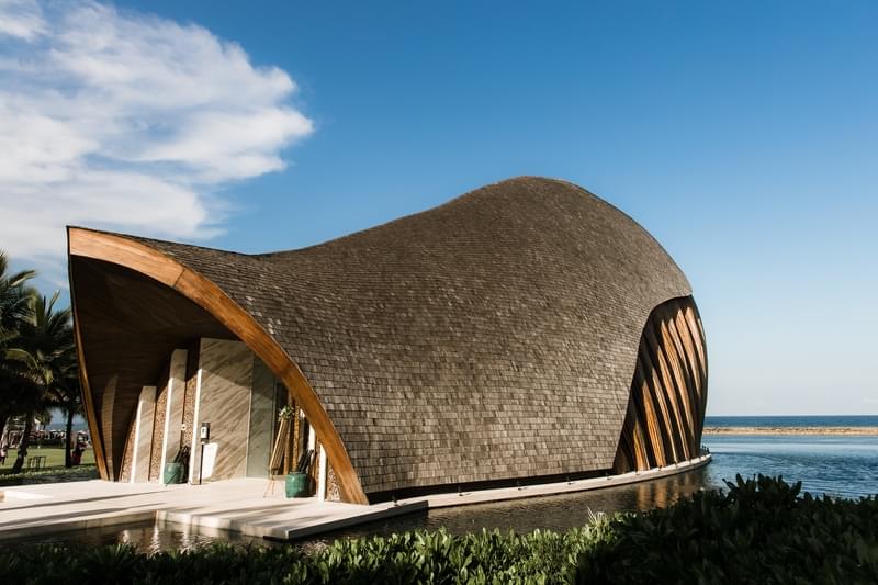  Exterior view of the Majestic Chapel at The Apurva Kempinski Bali, featuring modern architecture and ocean views in the background 