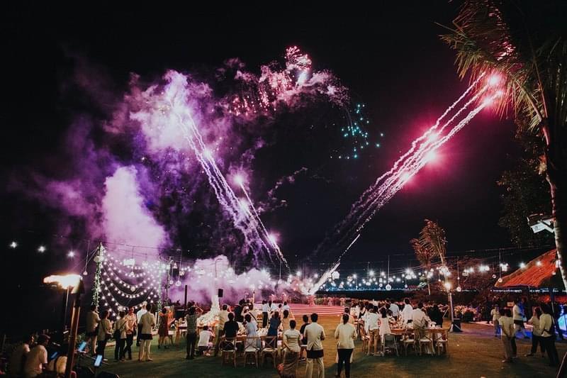 Spectacular fireworks display lighting up the night sky during a wedding celebration at Ayana Villa, surrounded by an elegant outdoor setup and festive ambiance