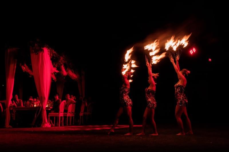  Fire dancers captivating the audience with a dramatic performance under the night sky at The Ungasan 