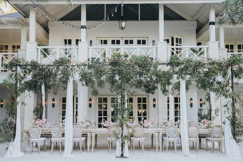  Beautifully decorated outdoor dining setup with vintage chairs and floral arrangements at Villa Tamarama in The Ungasan 